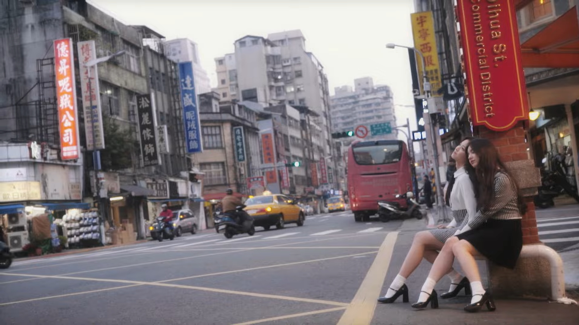 Heejin and Hyunjin resting in the city.